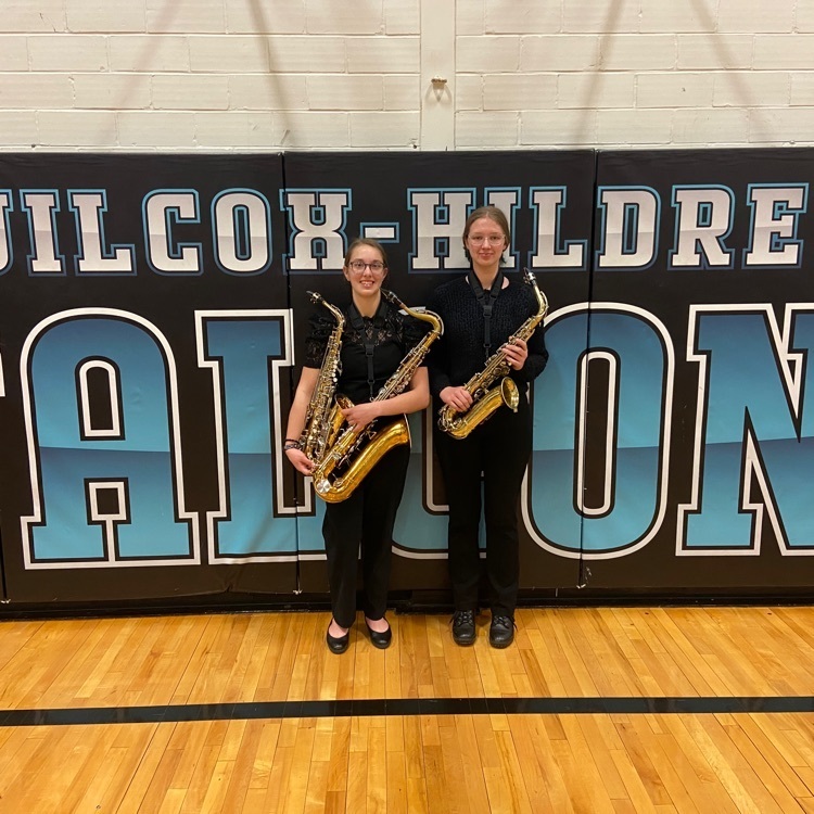 Alex and Brie holding their instruments
